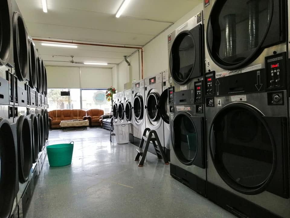 Rows of stacked commercial dryers inside the laundromat
