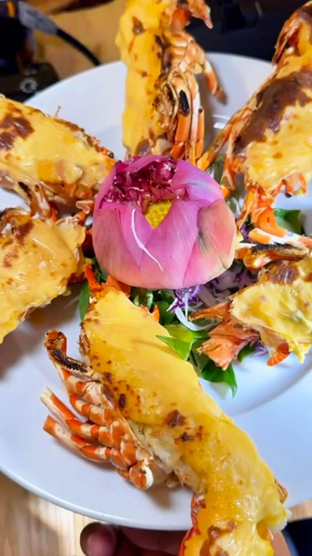 A beautifully plated Vietnamese seafood dish with lotus flower garnish