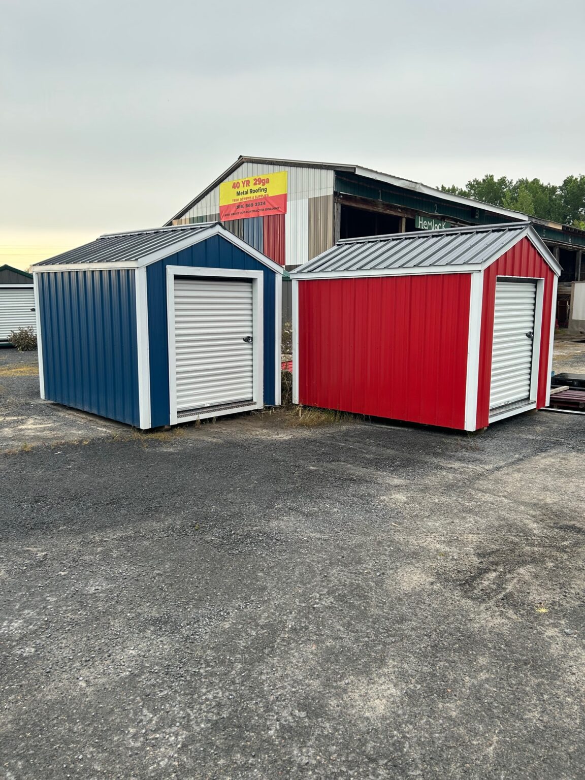 Blue and red drive-up storage units in front of facility building at Salty Rocks Storage