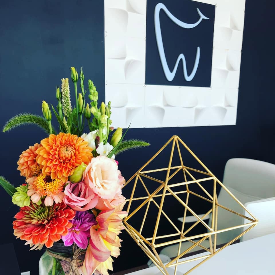 Denture Design Clinic reception area with colourful floral arrangement