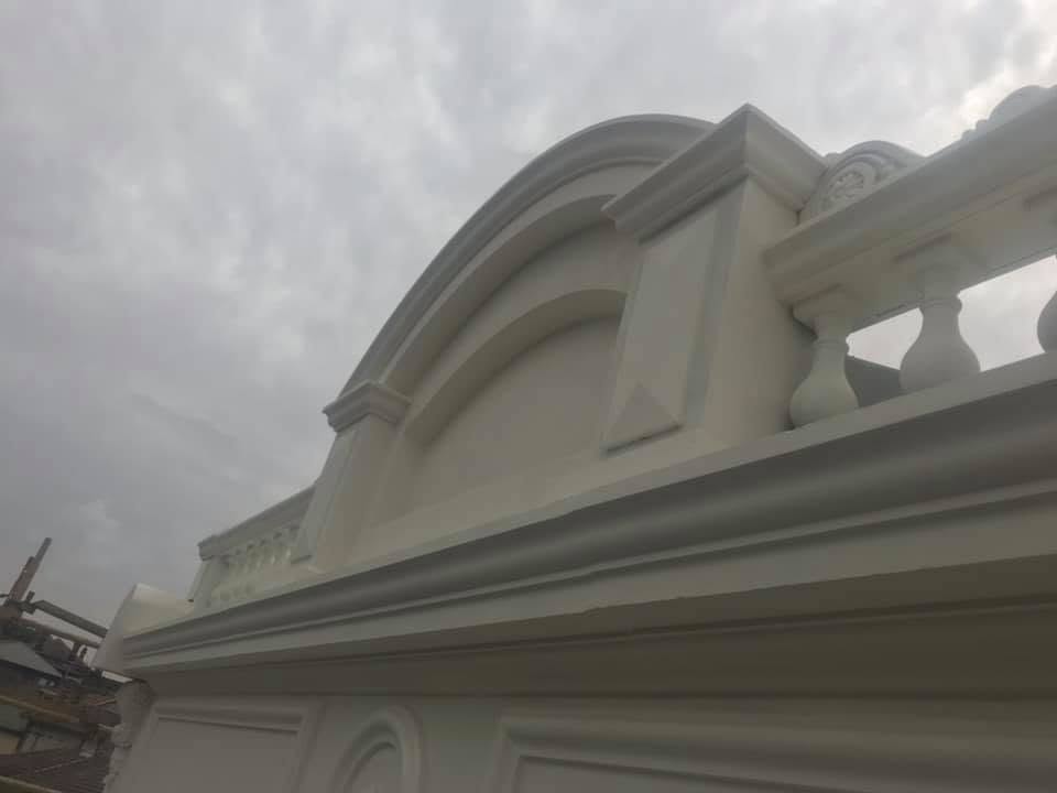 Ornate white rendered facade detail with dome and mouldings — renovation work by Primo Property Maintenance