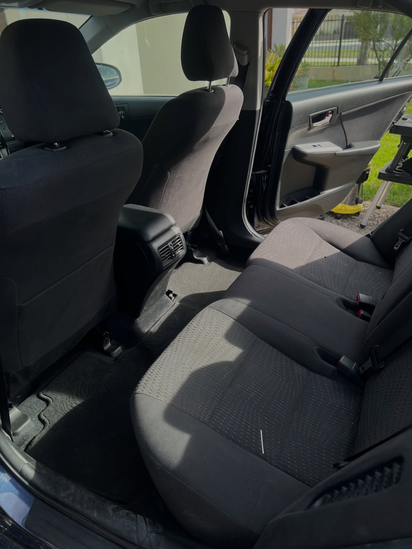 Freshly cleaned rear seats and carpet inside a sedan