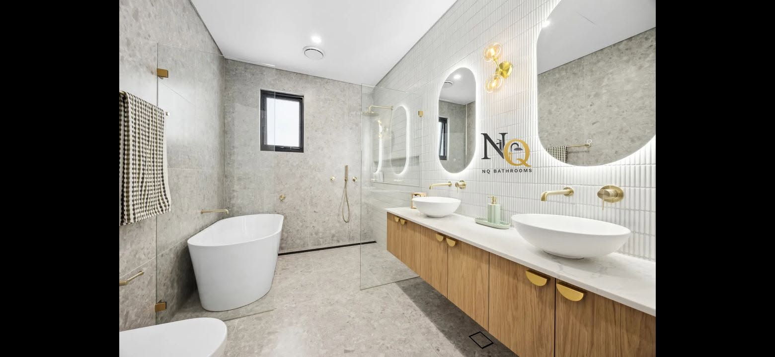 Luxury bathroom renovation by NQ Bathroom — double vanity with gold fixtures and freestanding bath