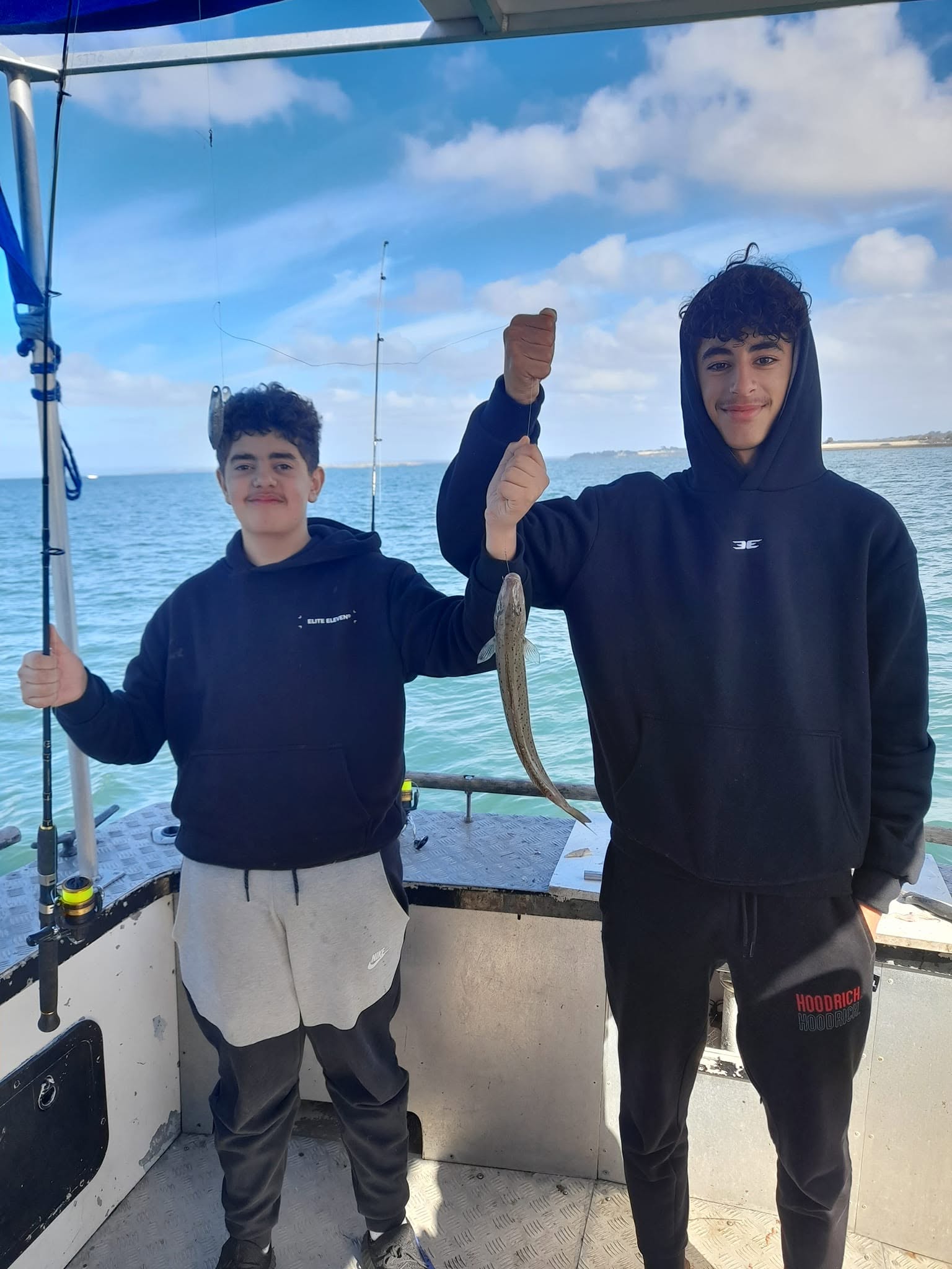 Two young anglers on board showing their catch of the day