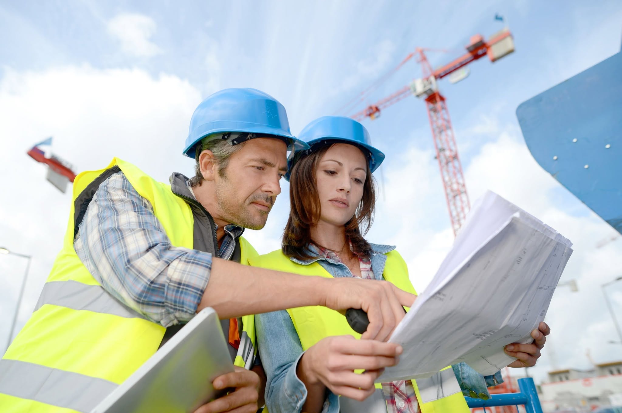 Construction professionals reviewing project plans on a building site