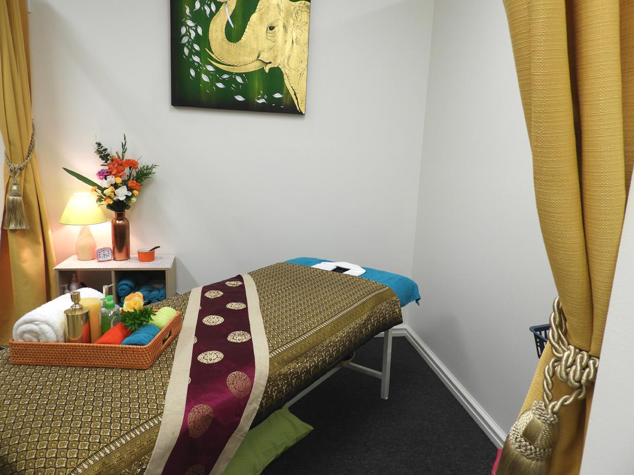 Peaceful treatment room with earthy tones and elephant artwork at Golden Orchid