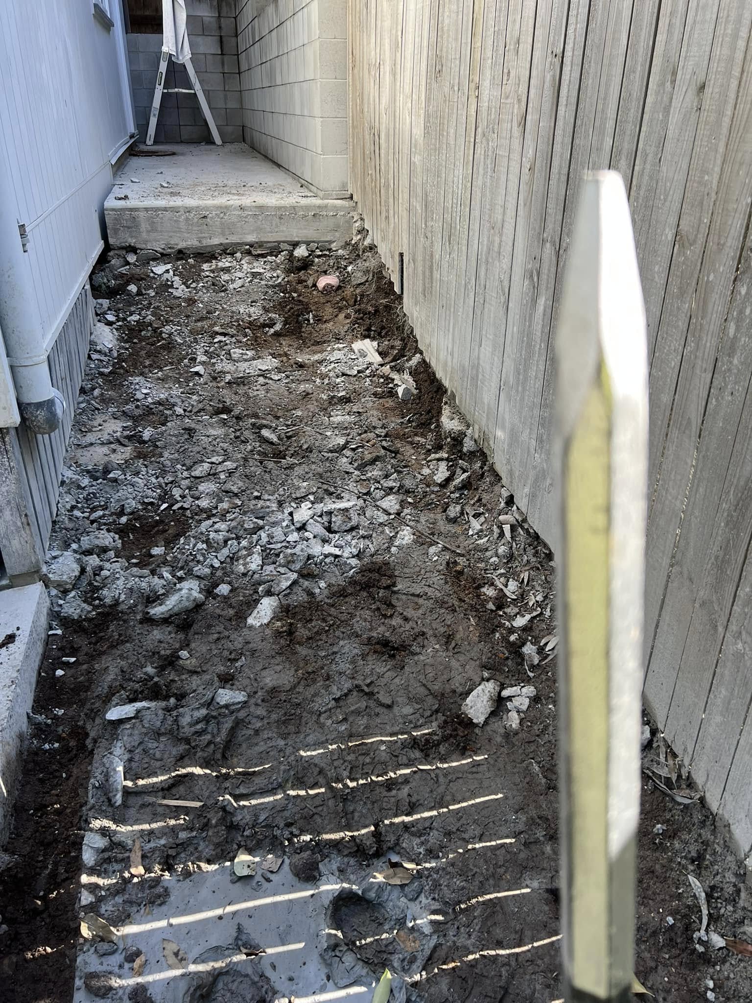 Diamond saw concrete cutting equipment set up inside a concrete structure with slurry on walls