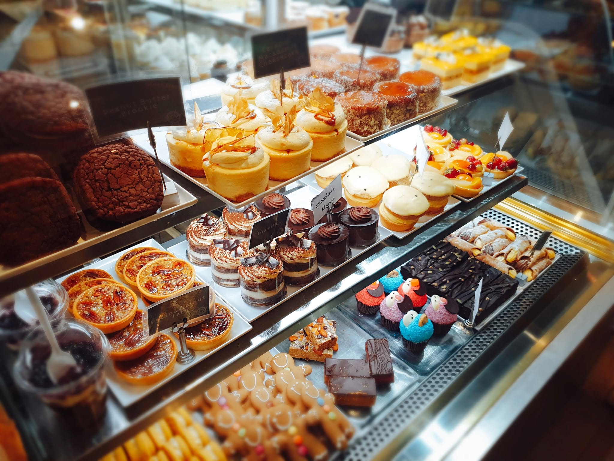 A display case of assorted cakes, tarts and pastries at Schwabs Galley