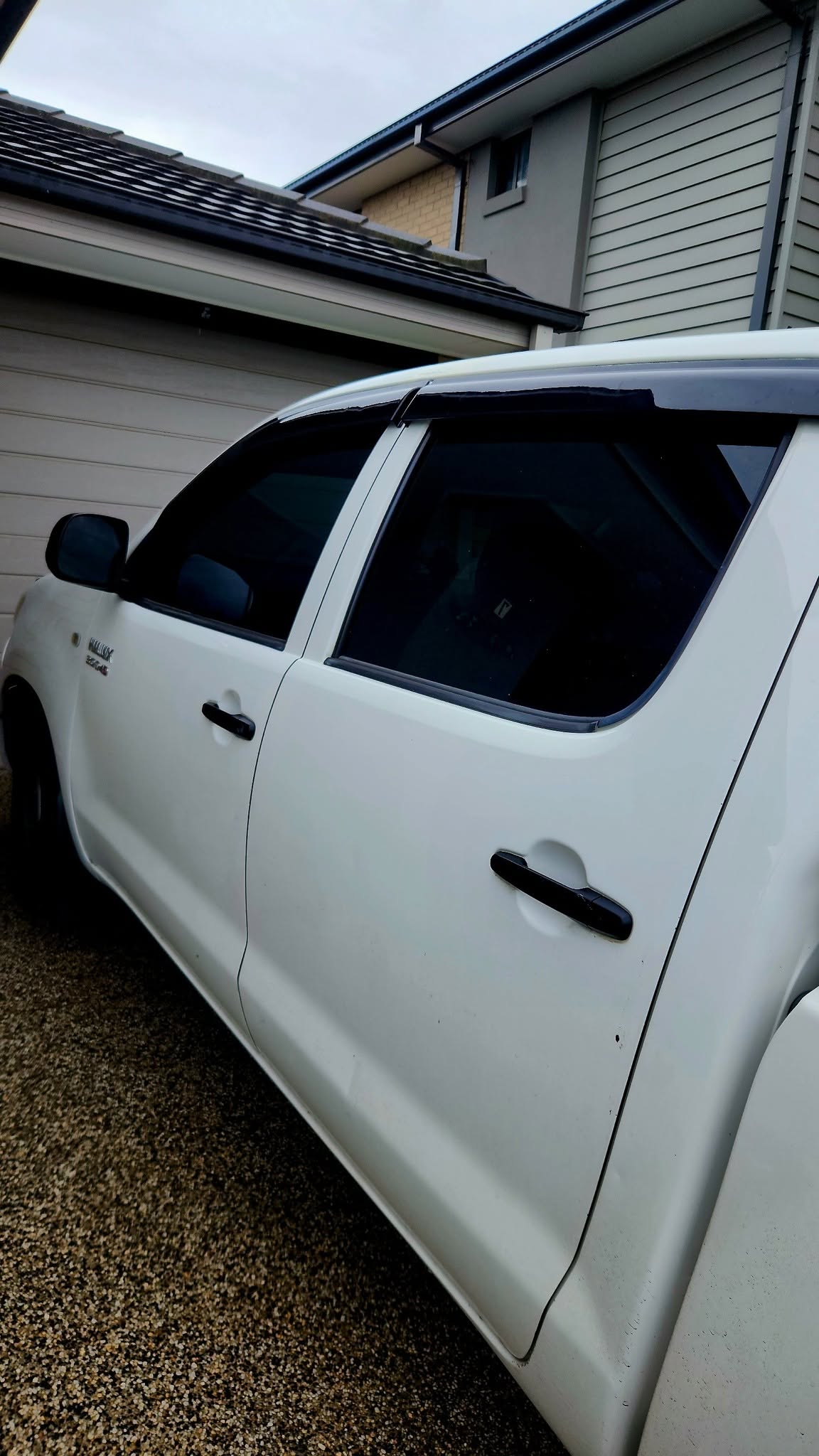 White dual-cab ute with freshly tinted front window