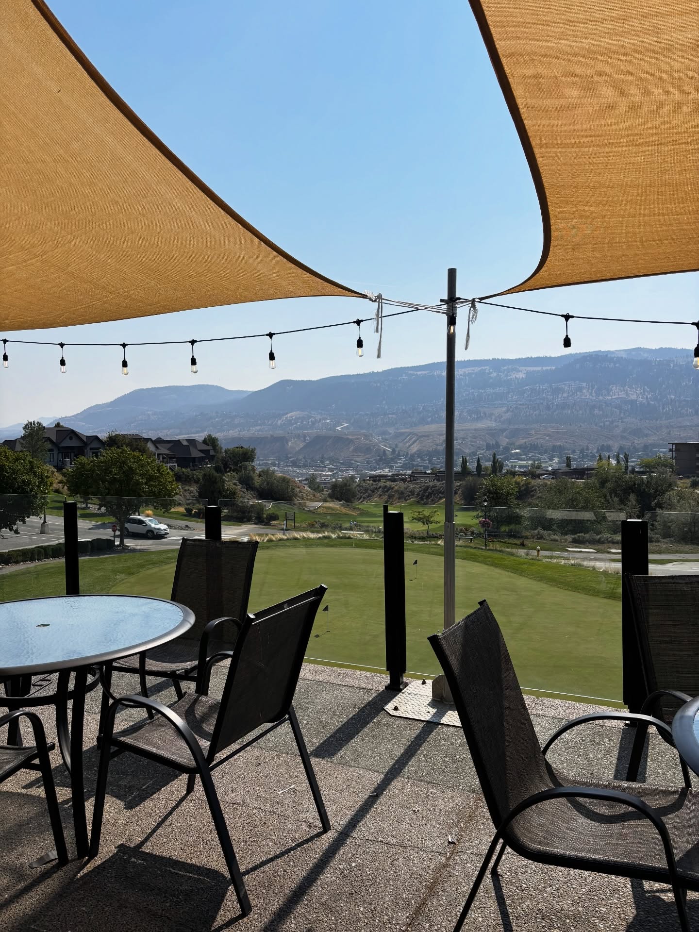Outdoor patio dining table with mountain and golf course views at Mason's Kitchen
