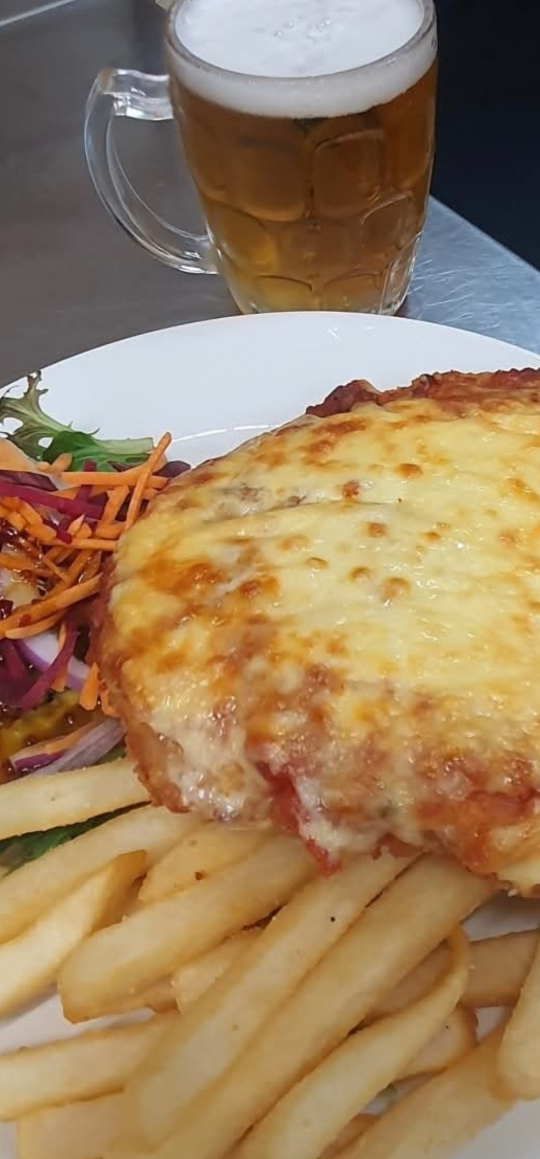 Classic chicken parmi with chips and salad served at The Yardz Hotel