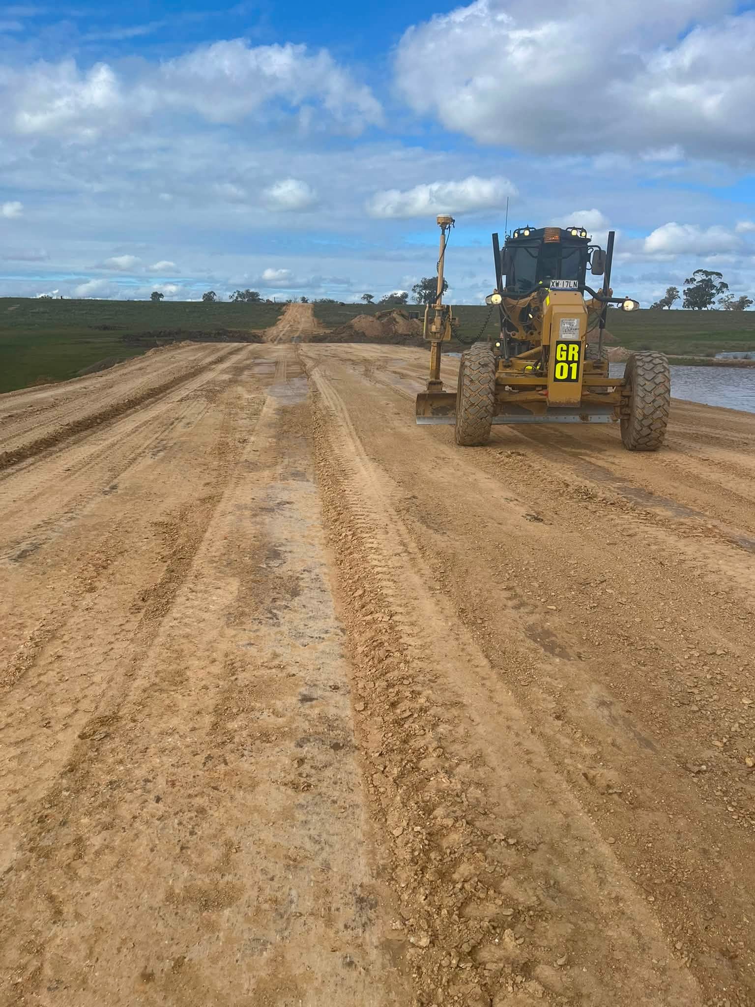 GPS grader working on rural road construction in Central Victoria