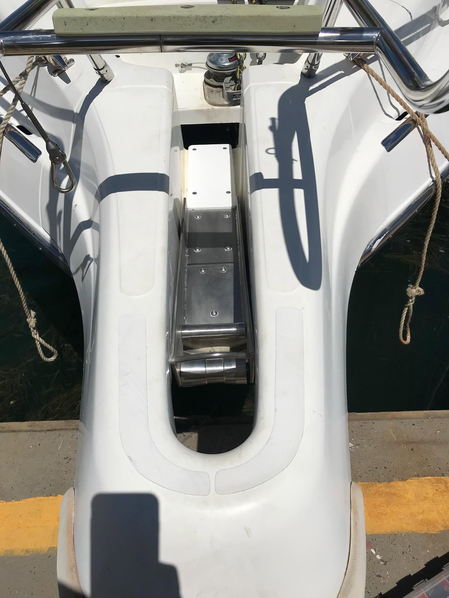 Custom stainless steel bow roller assembly fitted to a vessel at the marina