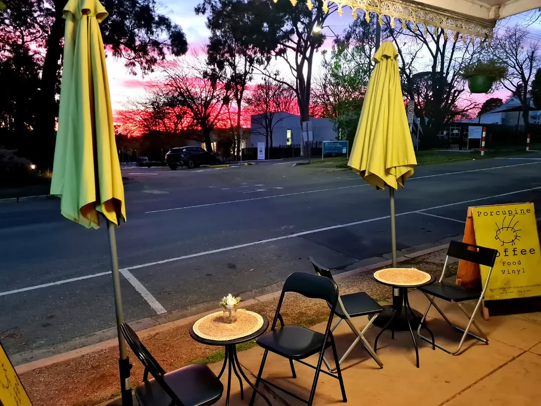 Porcupine Music Store outdoor seating area at dusk with yellow umbrellas, Monbulk VIC