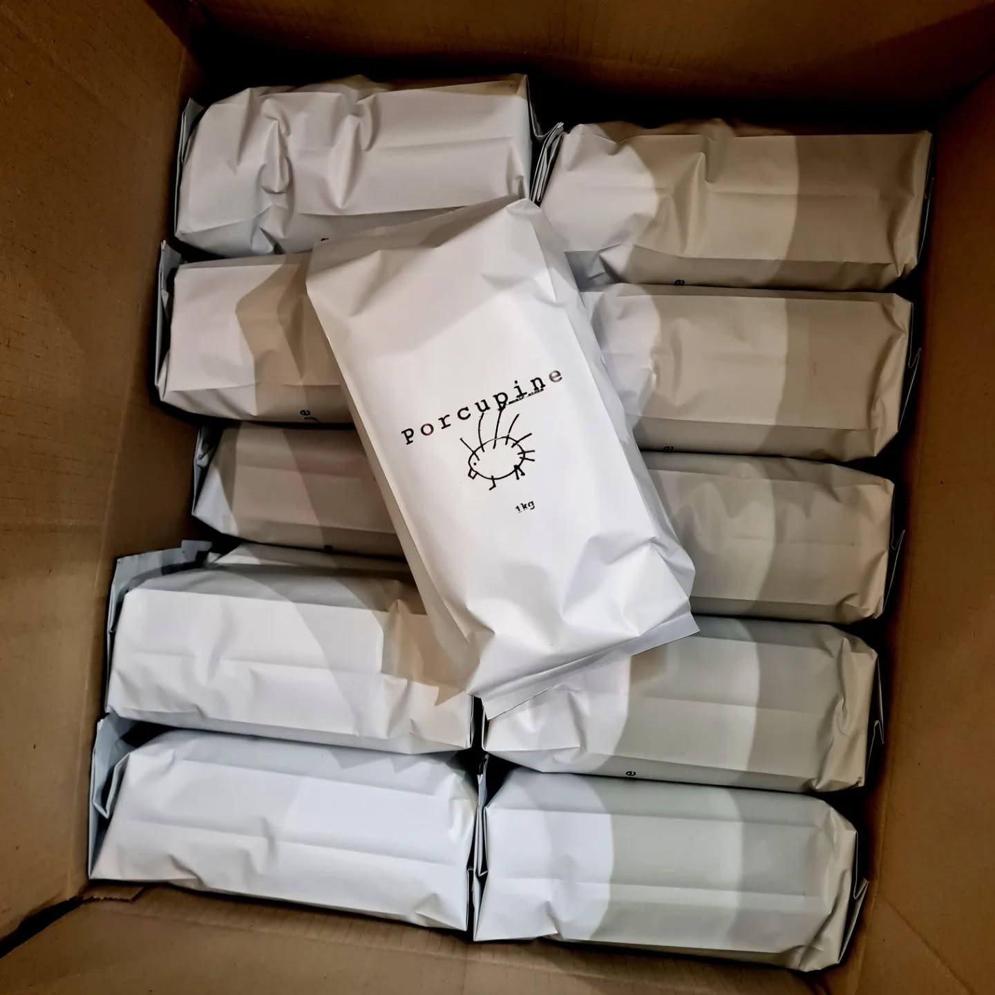 Porcupine branded merchandise — coffee bags packed in a box, Monbulk store