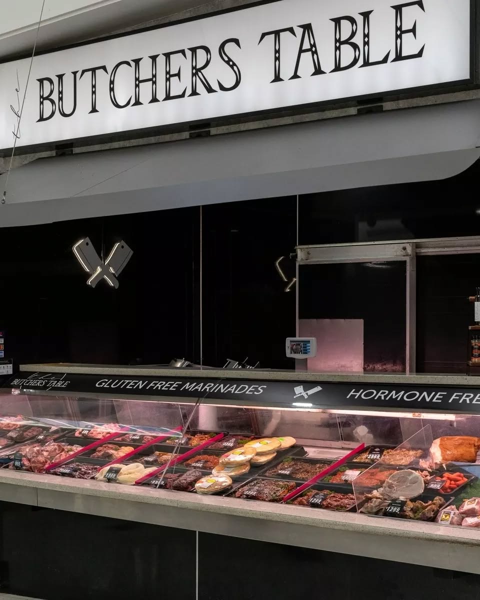The Butchers Table shop front at Stockland Burleigh Heads showing the illuminated signage and full display counter