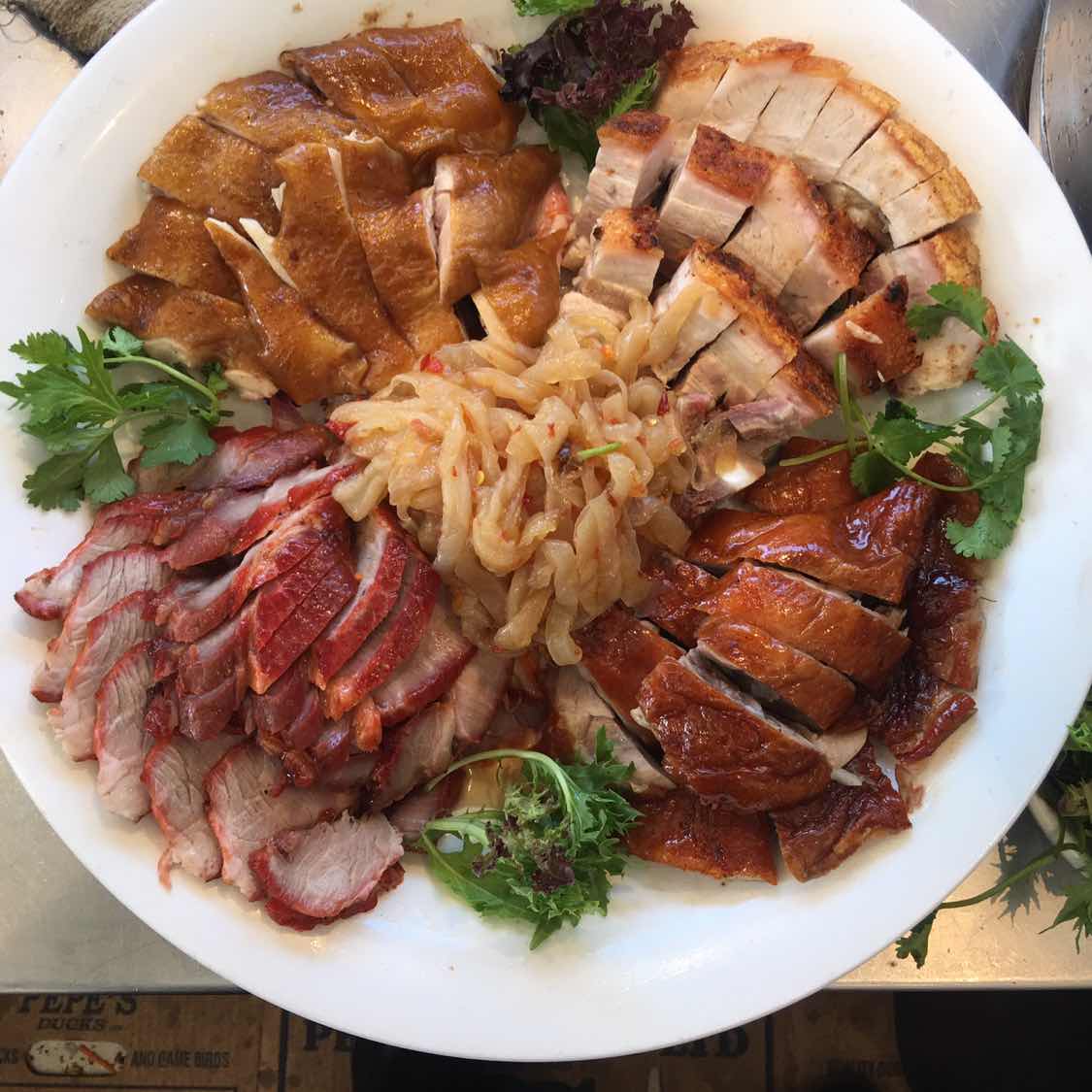 Platter of BBQ roasted meats including char siu, duck and chicken