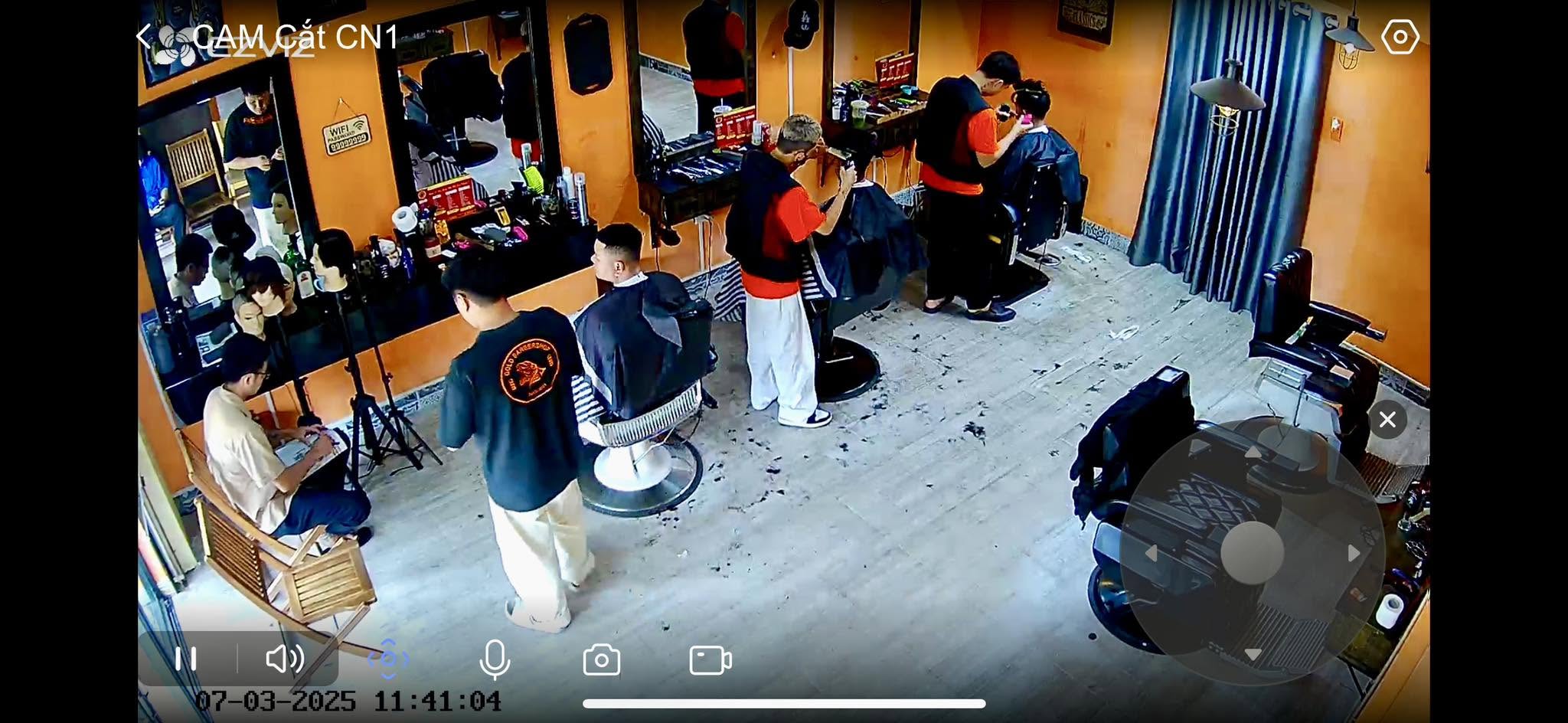 G Gold Barbershop — barbers at their stations serving clients