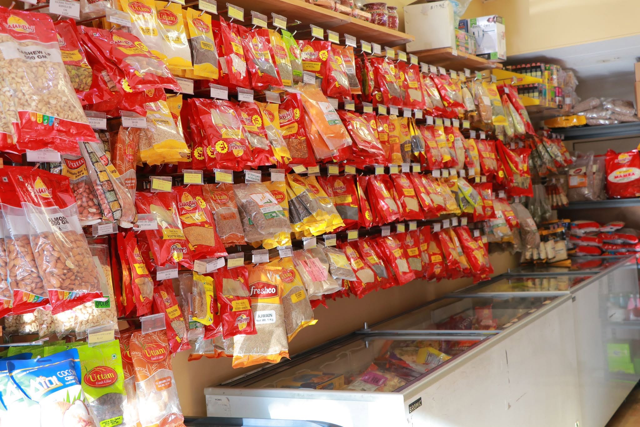 Shelves stocked with South Asian spices, nuts and cooking ingredients inside RB Mini Mart