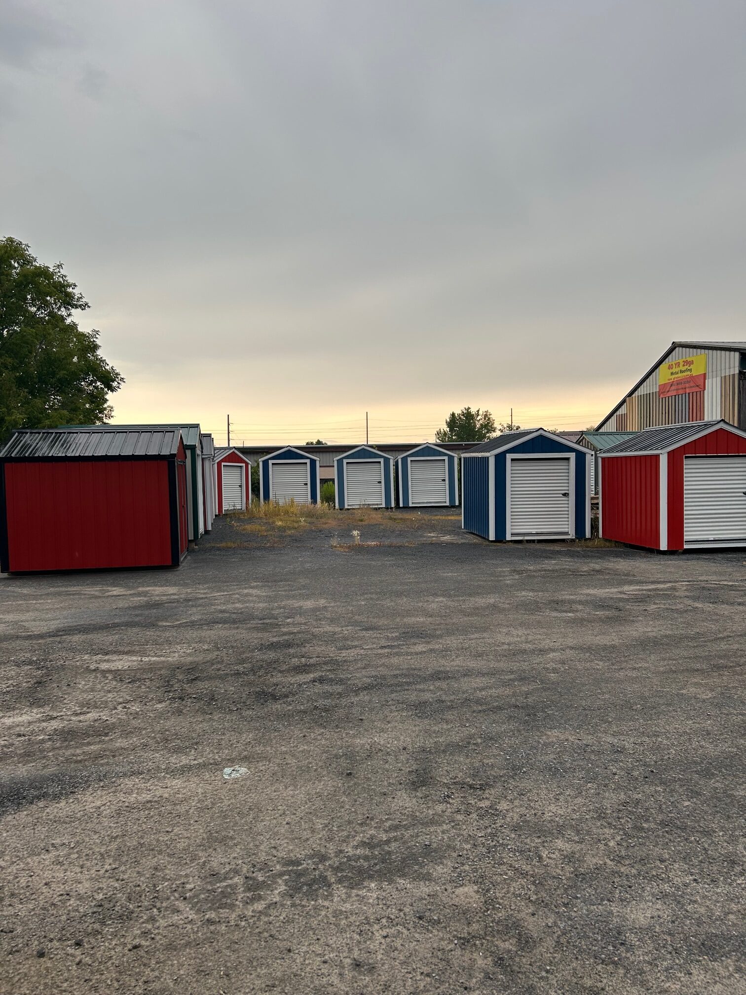 Wide view of the Salty Rocks Storage lot with red and blue drive-up units at dusk