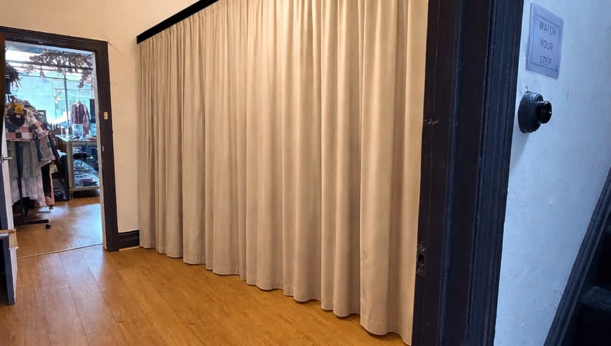Private consultation room with curtain divider providing a calm, private therapy space