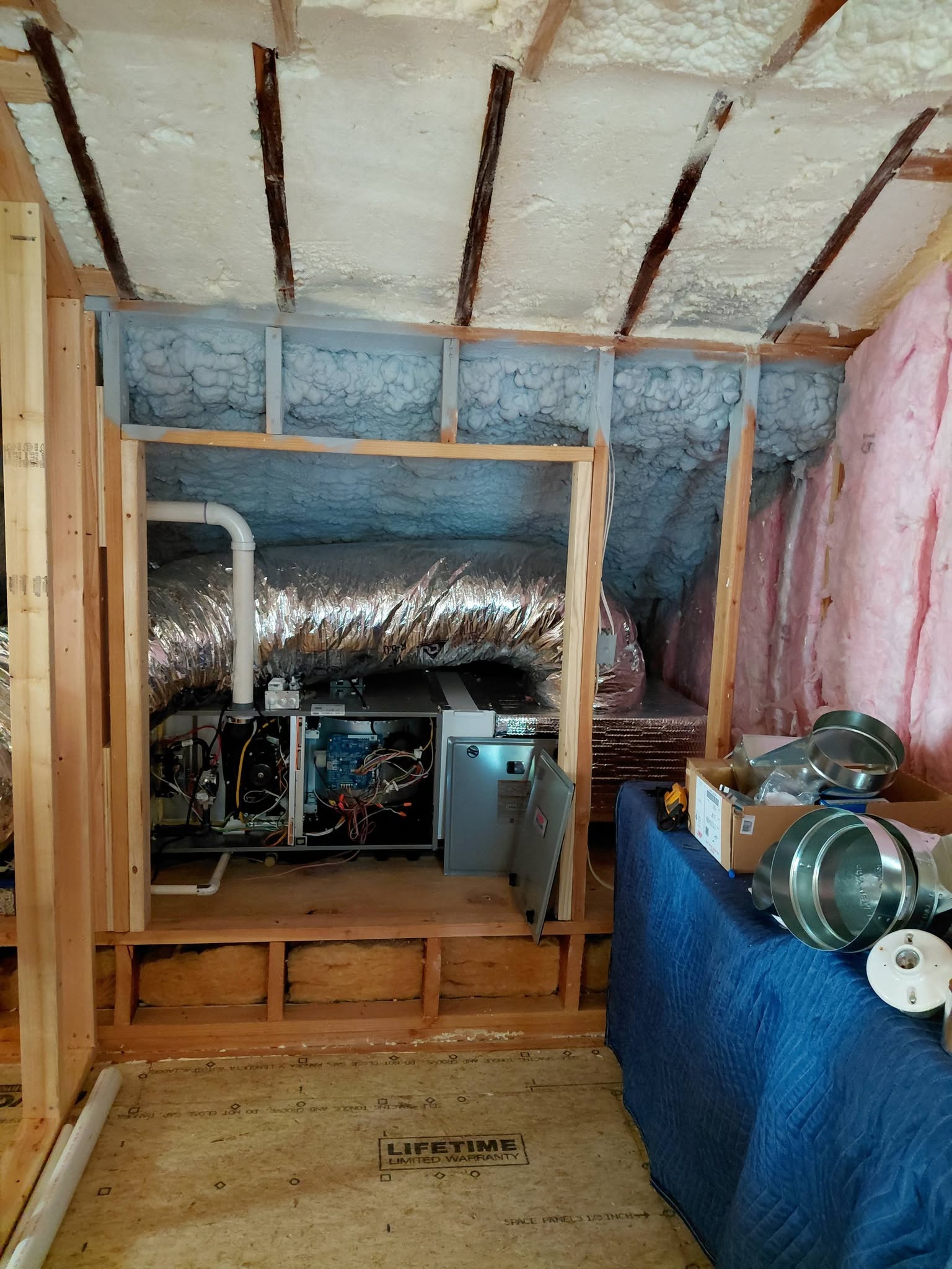 HVAC and electrical installation inside a timber-framed building under construction
