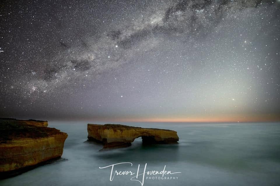 Night sky over a rock arch on the Great Ocean Road coastline near Port Campbell