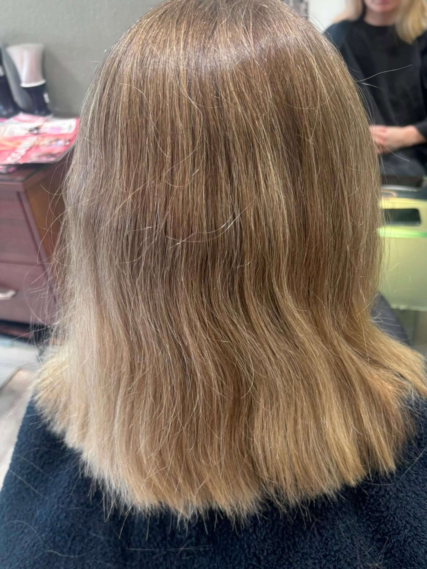 Smooth warm blonde hair after keratin treatment