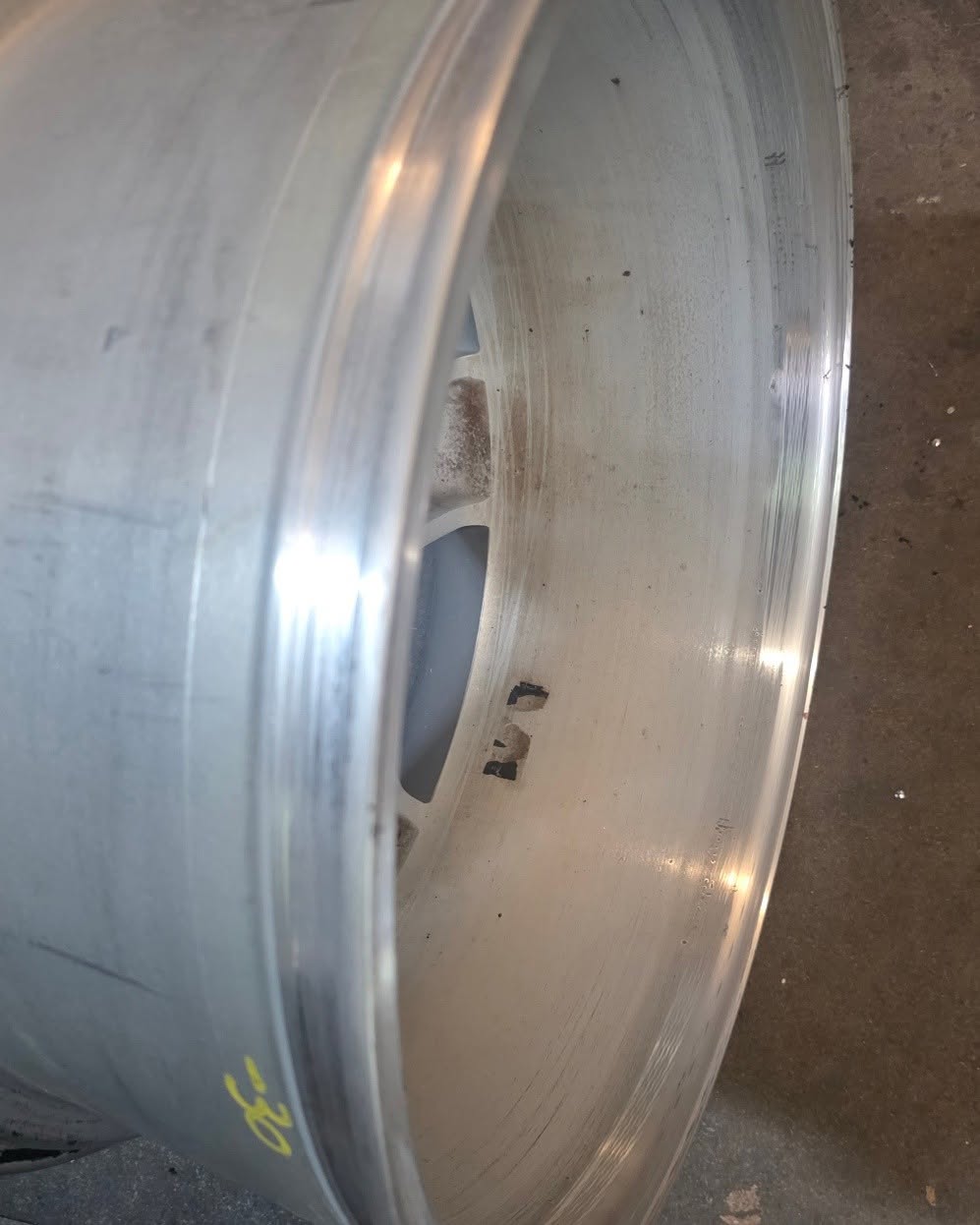 Close-up of restored alloy wheel barrel inner lip with polished edge