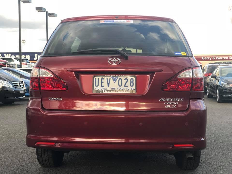 Red Toyota Avensis Verso at the Garry and Warren Smith Used Cars dealership – rear view showing GWS signage