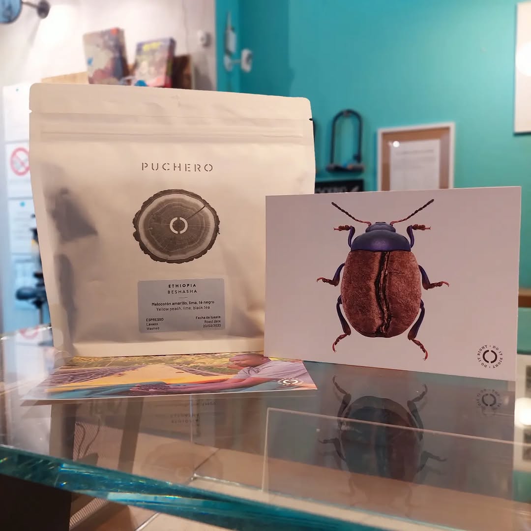A specialty coffee bag and coffee bean illustration card on a glass counter