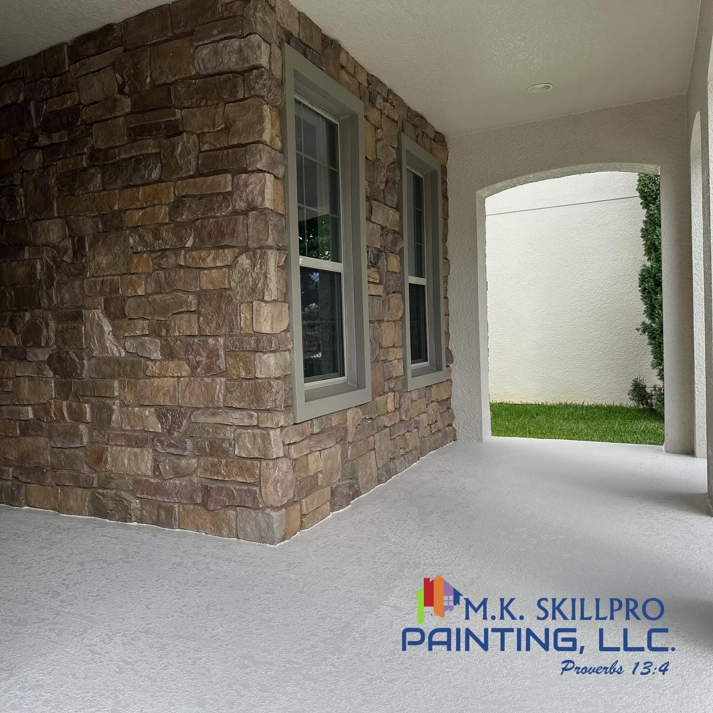Stone and stucco home exterior with freshly painted concrete floors