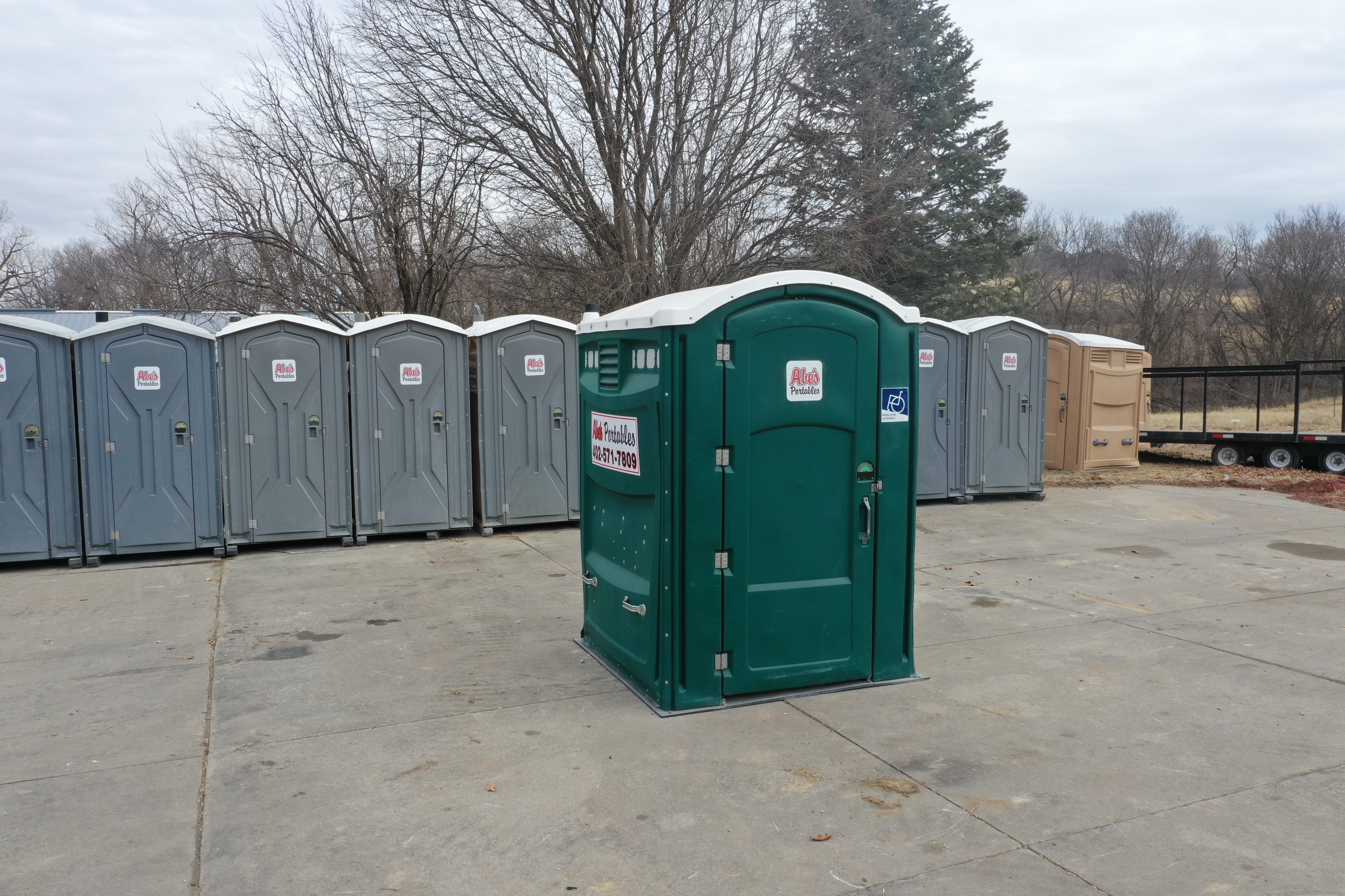 Abe's ADA-accessible green portable unit with standard units in the background