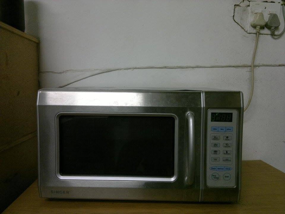 Stainless steel microwave oven being serviced