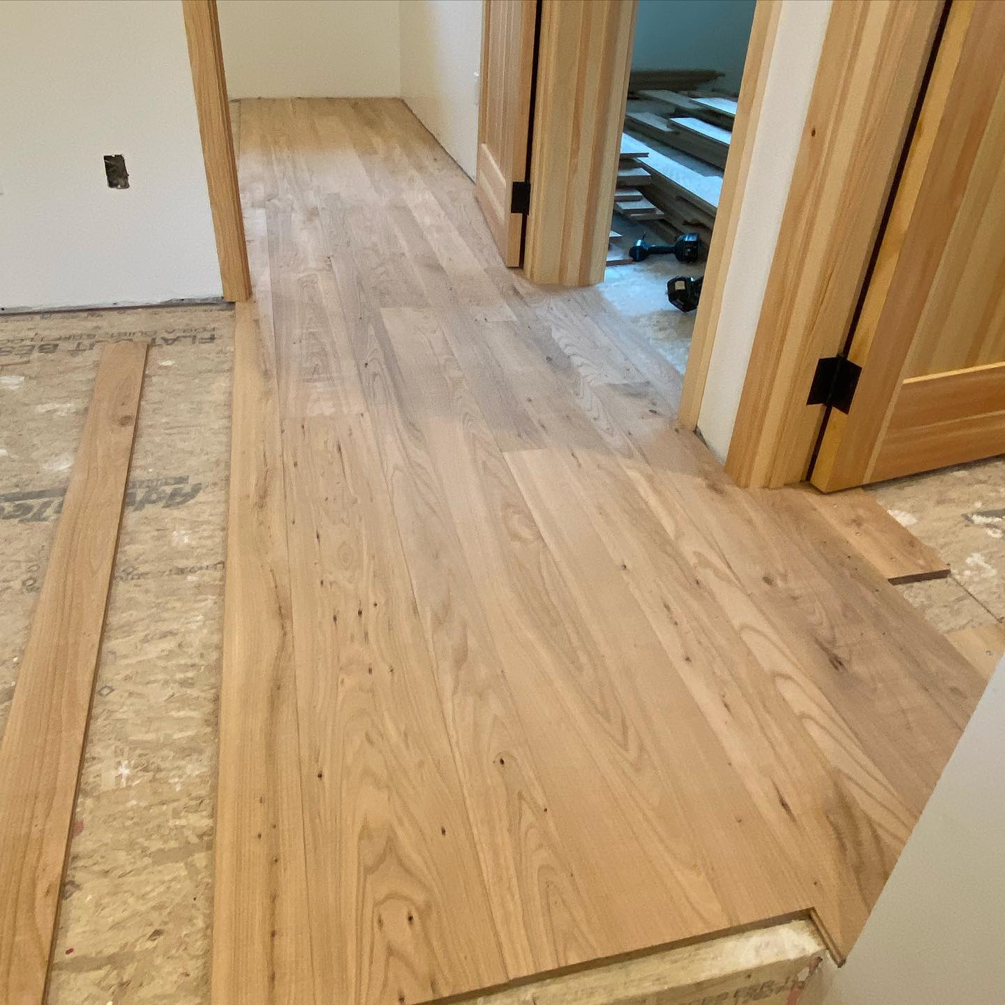 Hallway hardwood floor installation in progress