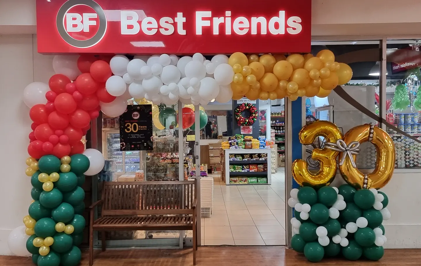 Best Friends storefront at McWhirters Center decorated with red, white, gold and green balloons