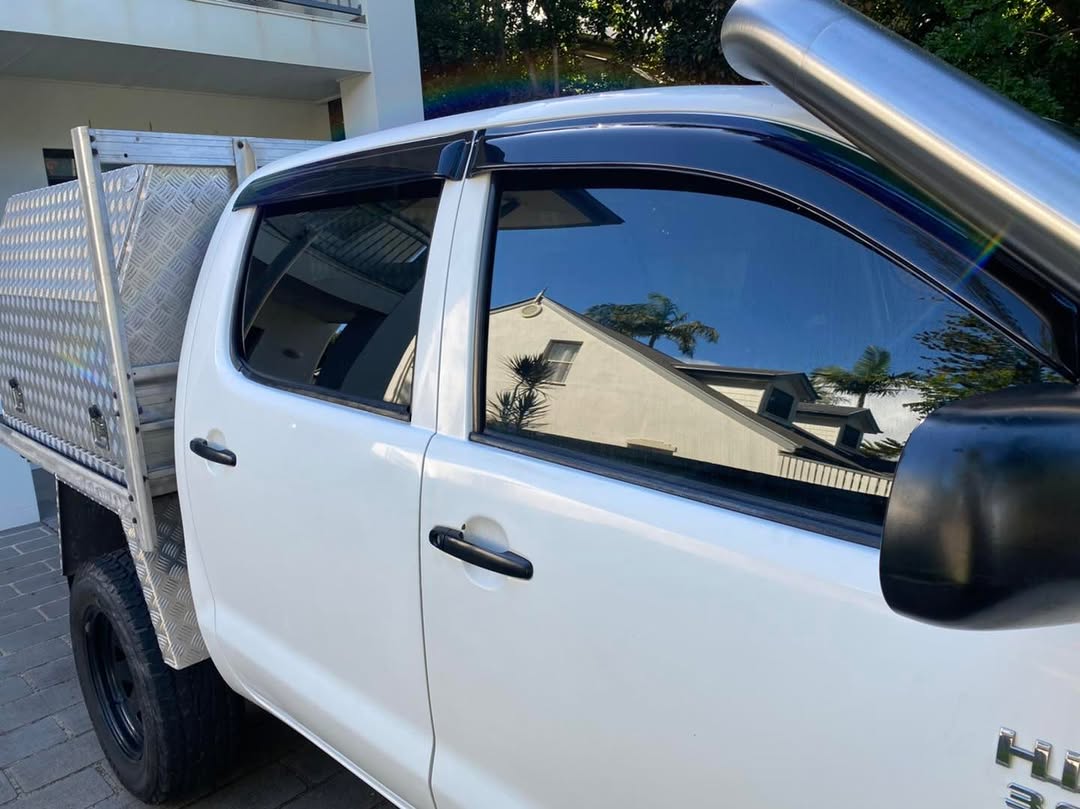 White tray-back ute with tinted front window