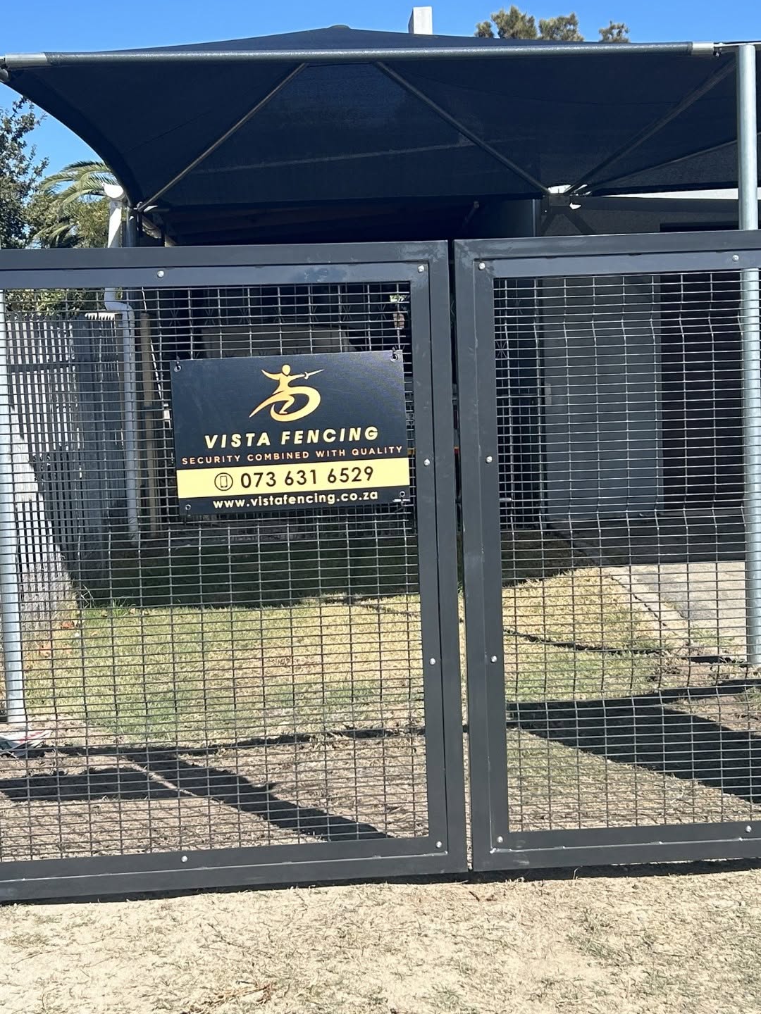 Vista Fencing branded double steel gate with gold signage plaque
