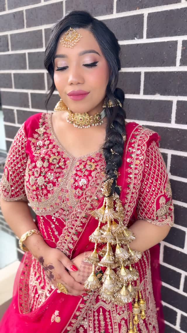 Hairstyling — client with a traditional braid adorned with gold tassel accessories