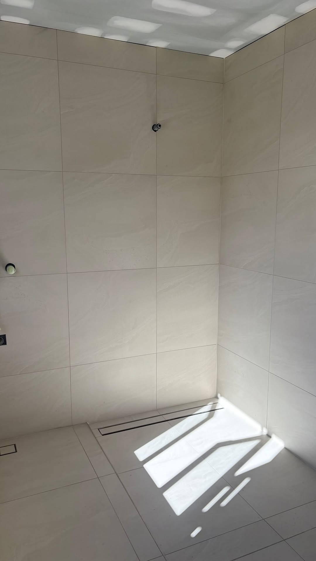 Clean tiled renovation space — interior finishing work