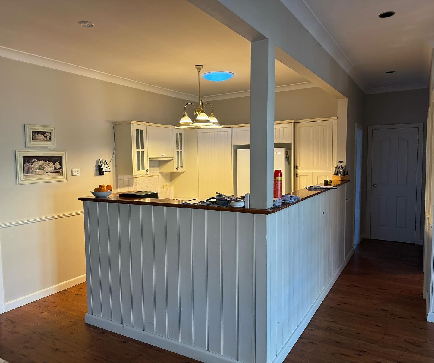 Completed whole-home renovation by Nelson Constructions — open-plan kitchen with timber bar and pendant lights