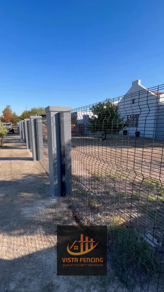 Vista Fencing — long run of black palisade security fencing with mountain backdrop