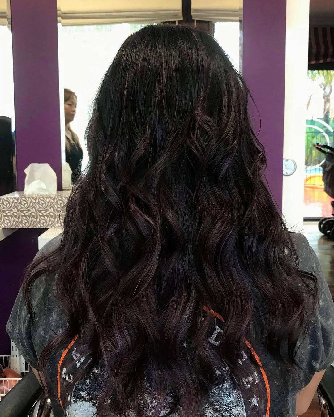 Dark plum wavy hair with rich colour tones — NAIDAS HAIRSALON