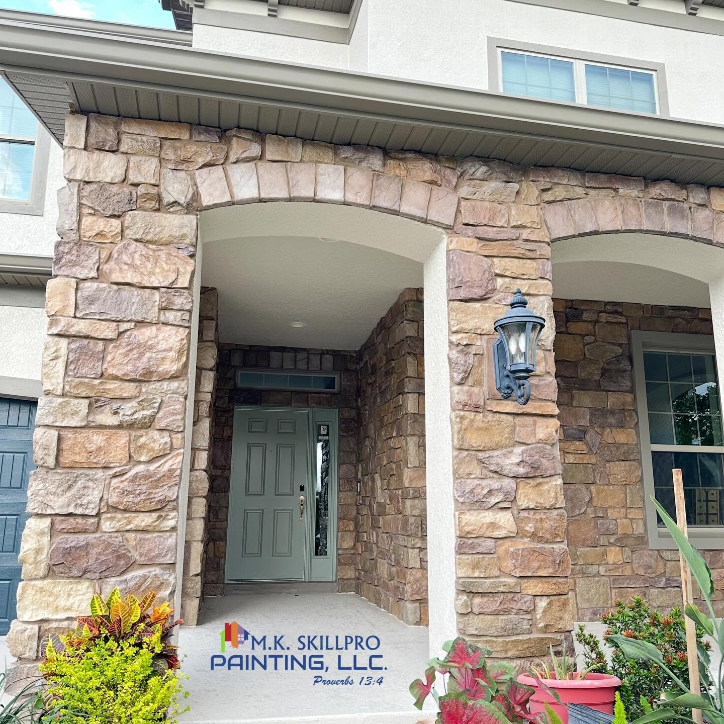 Freshly painted stone arch entrance and front door