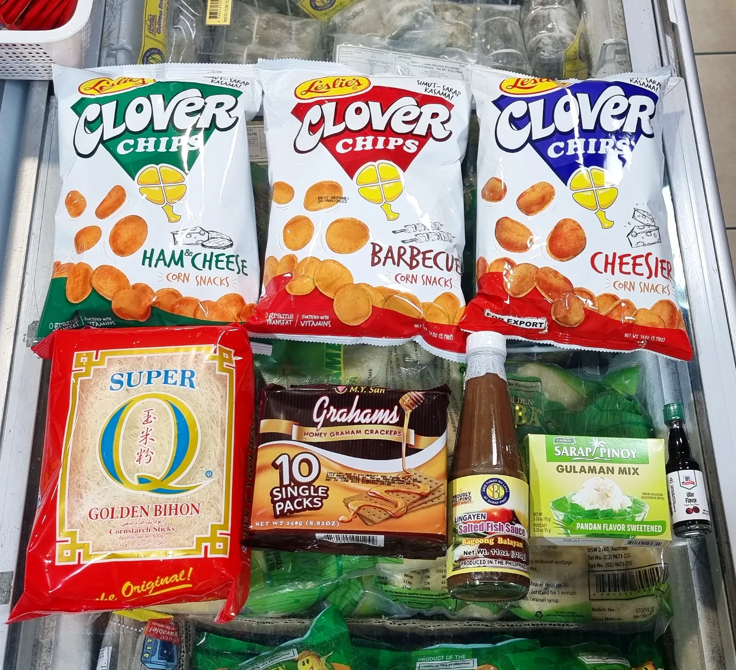 Bags of Clover Chips, golden bihon noodles, graham crackers and Filipino sauces on display