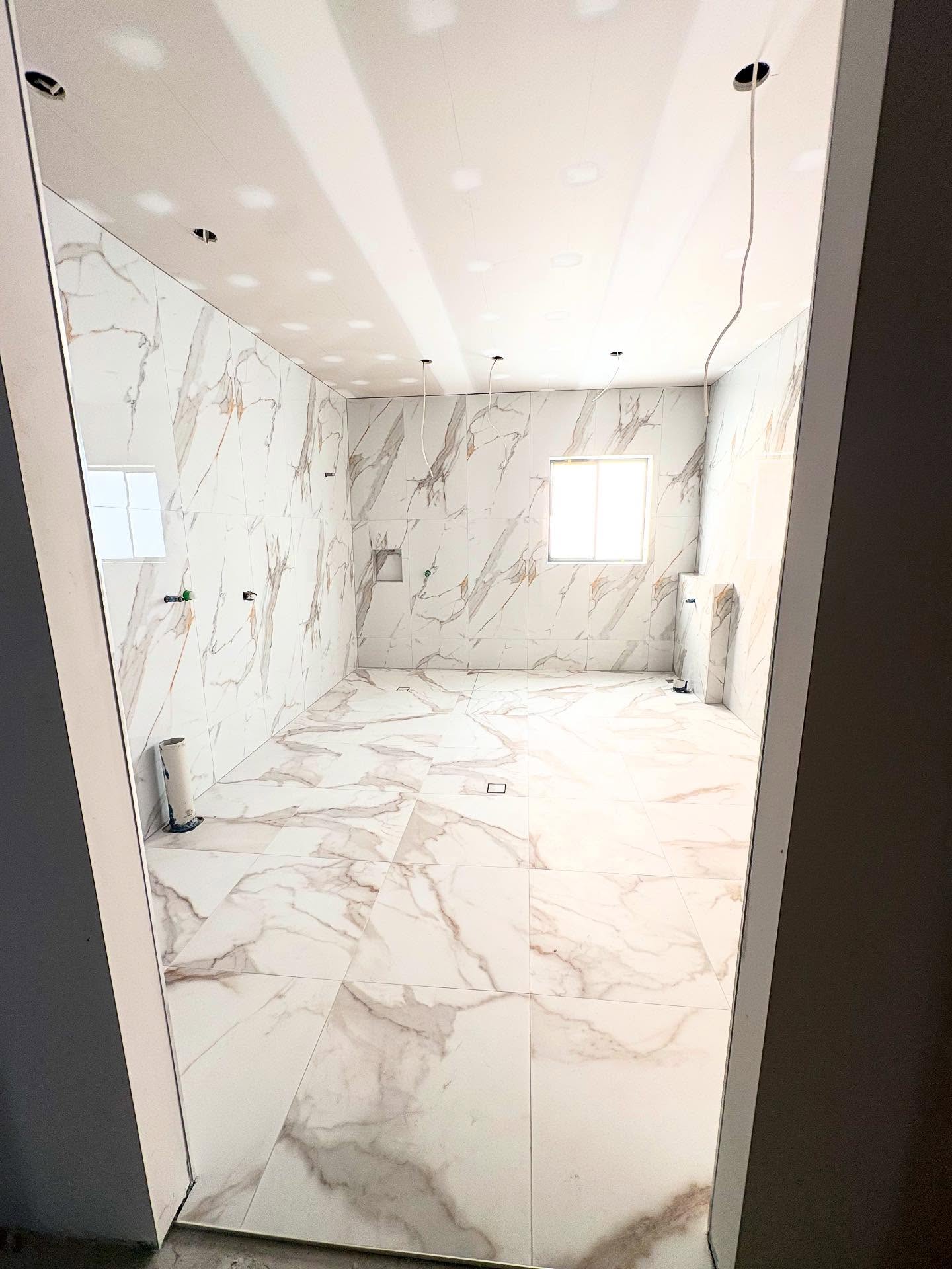 Marble-effect tiled bathroom renovation completed by Sunstone Co