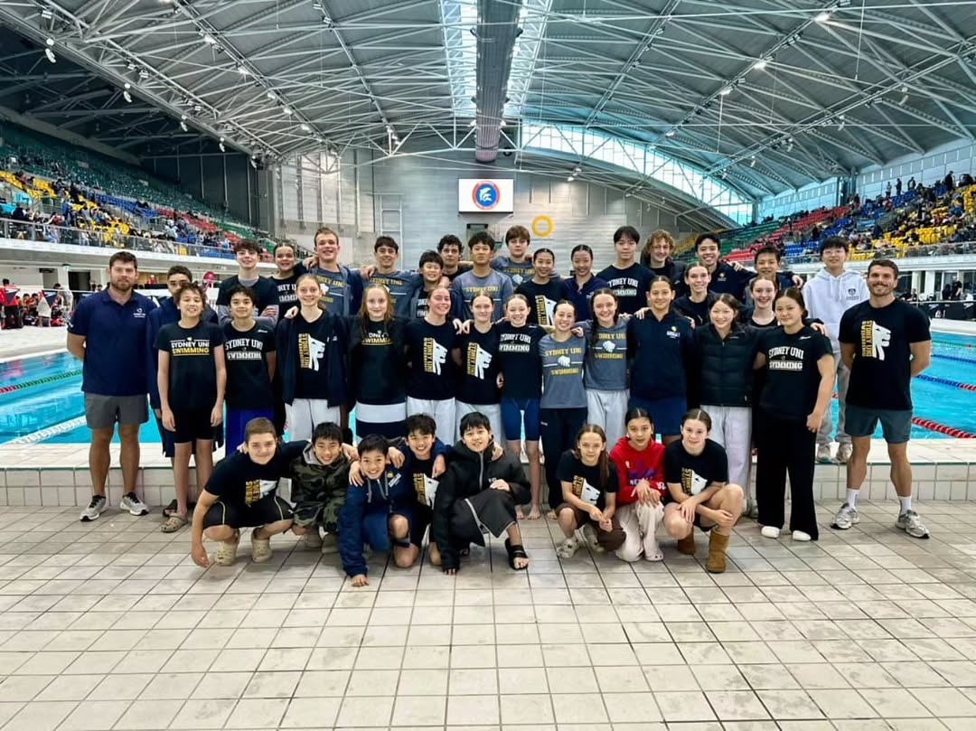 Large group of Sydney University Swimming Club members at an indoor aquatic centre