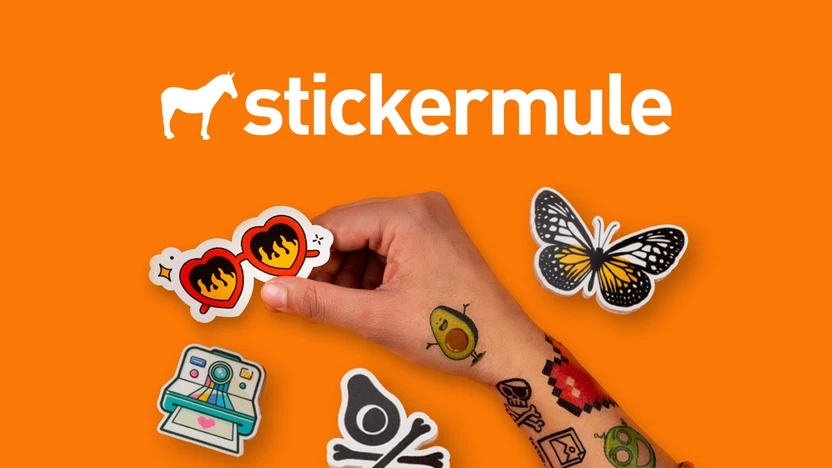 Hand holding custom stickers on orange background, showing butterfly, flame sunglasses, and avocado skull stickers