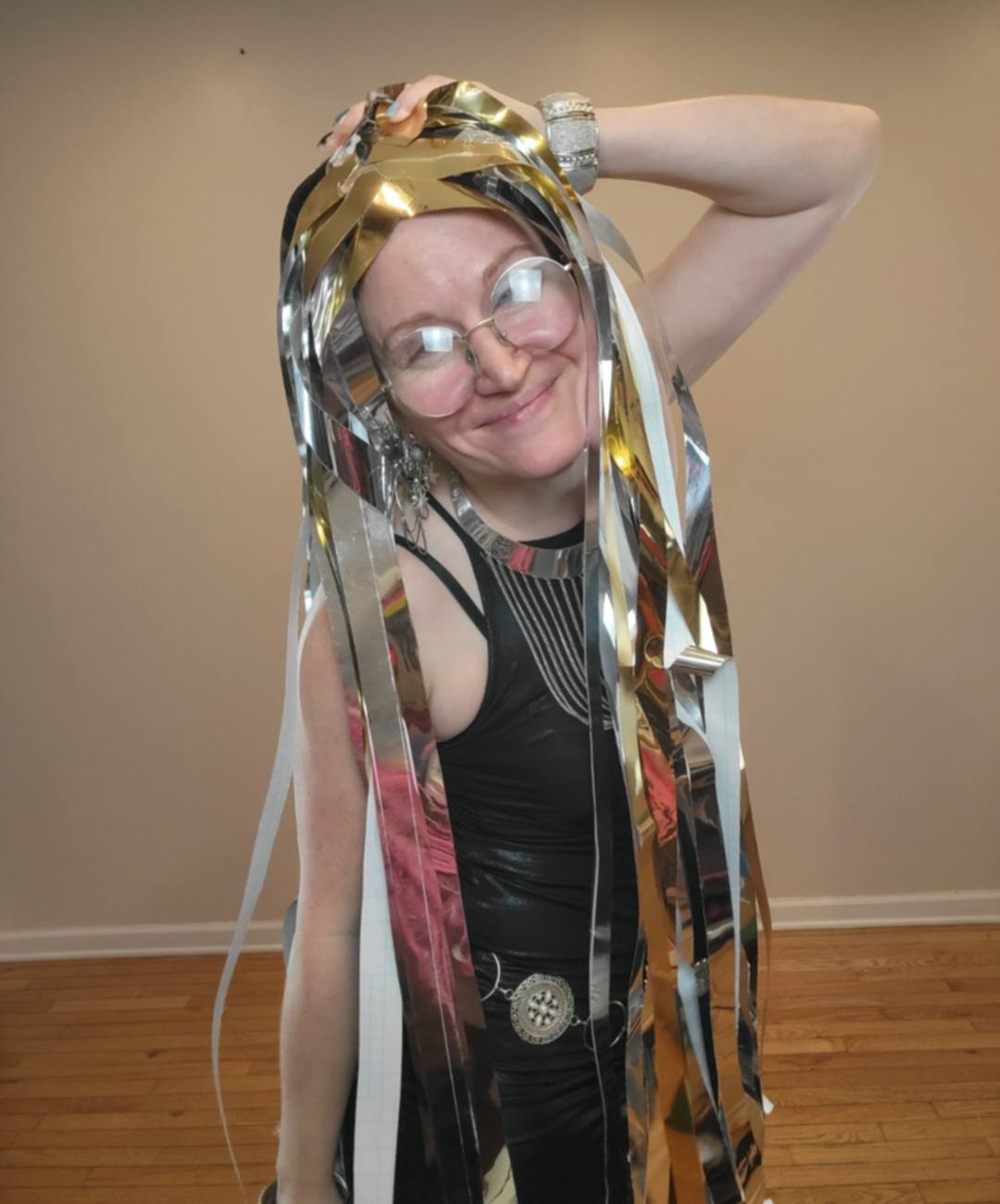 Donna wearing a gold and silver metallic streamer paper wig