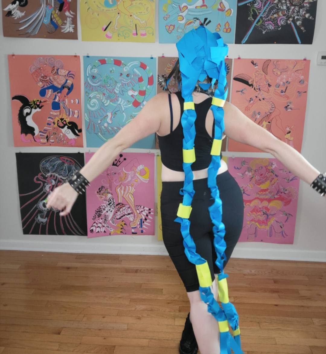 Back view of Donna Marie Milligan wearing a cobalt blue and neon yellow braided paper wig.